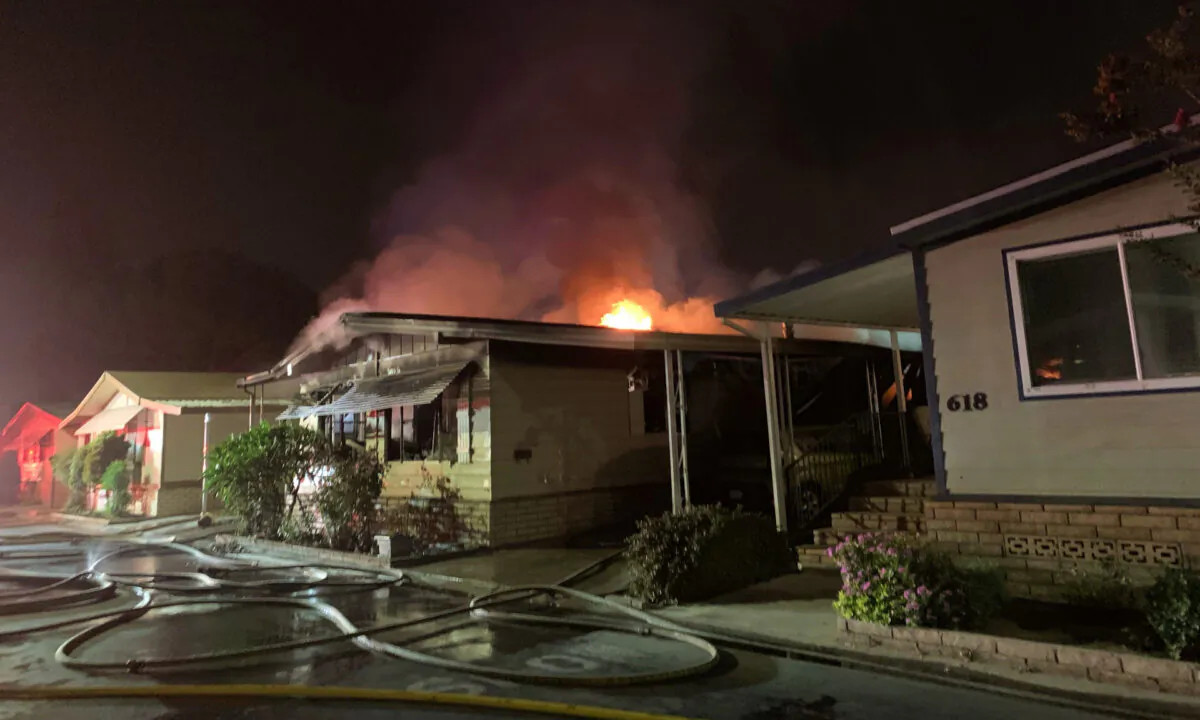 A deadly house fire burns in a mobile home park in Westminster, Calif., on Sept. 14, 2020. (Courtesy of the Orange County Fire Authority)