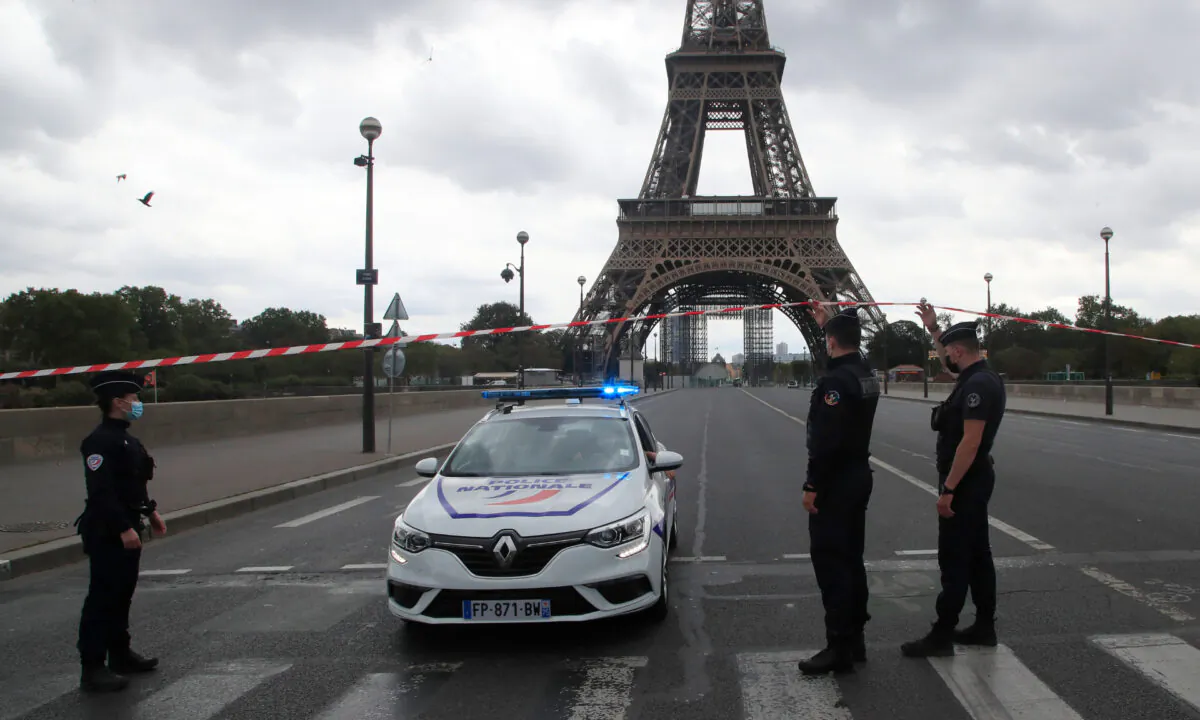 French police officers secure the bridge leading to the Eiffel Tower in Paris, on Sept. 23, 2020. (Michel Euler/AP Photo)