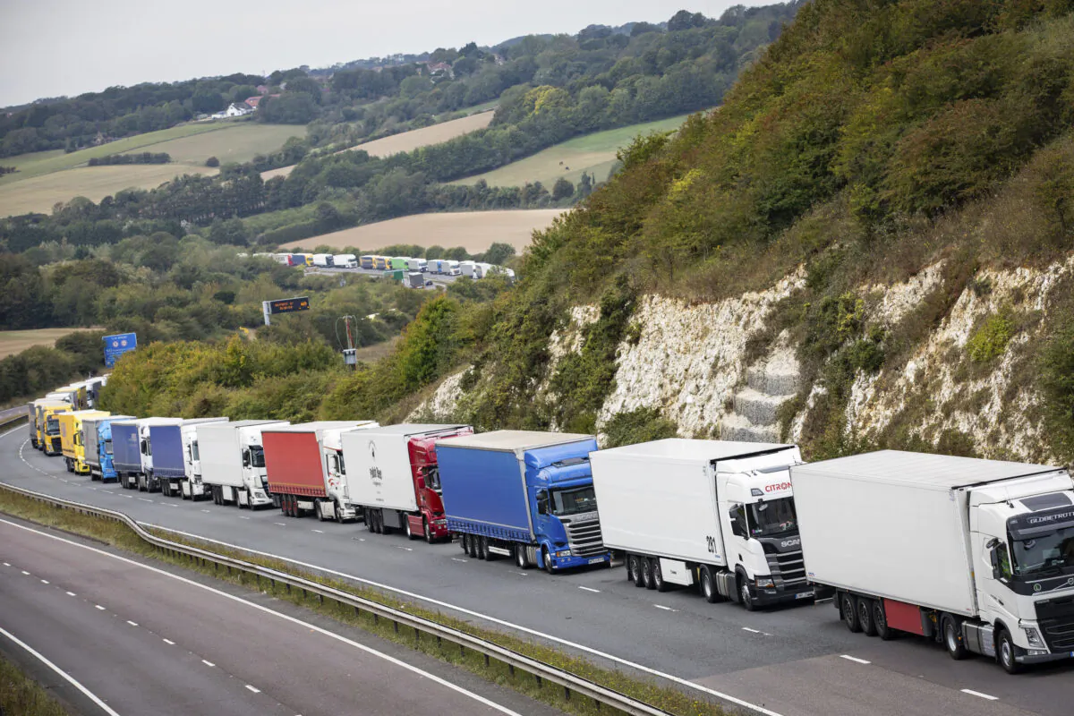 Heavy goods vehicles queue on a main road near Dover, southern England, after a police operation in the port city resulted in traffic congestion on nearby roads, on Sept. 16, 2020.  (Aaron Chown/PA via AP)