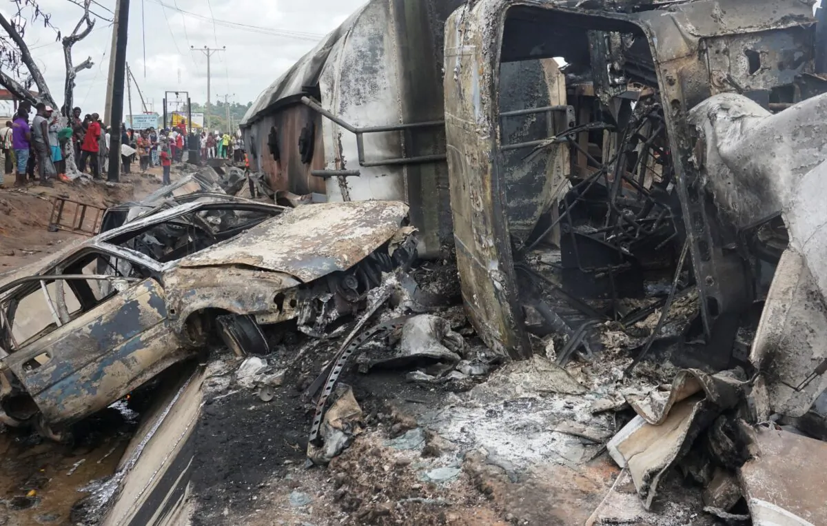 People inspect the damage at the site of a gas tanker explosion in the central Nigerian state of Kogi, Nigeria on Sept. 23, 2020. (Haruna Yahaya/Reuters)