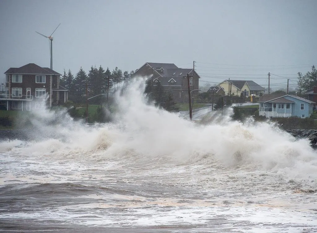 Waves batter the shore in Cow Bay, N.S., on Sept. 23, 2020. Hurricane Teddy has impacted the Atlantic region as a post-tropical storm, bringing rain, wind and high waves. (Andrew Vaughan/The Canadian Press)