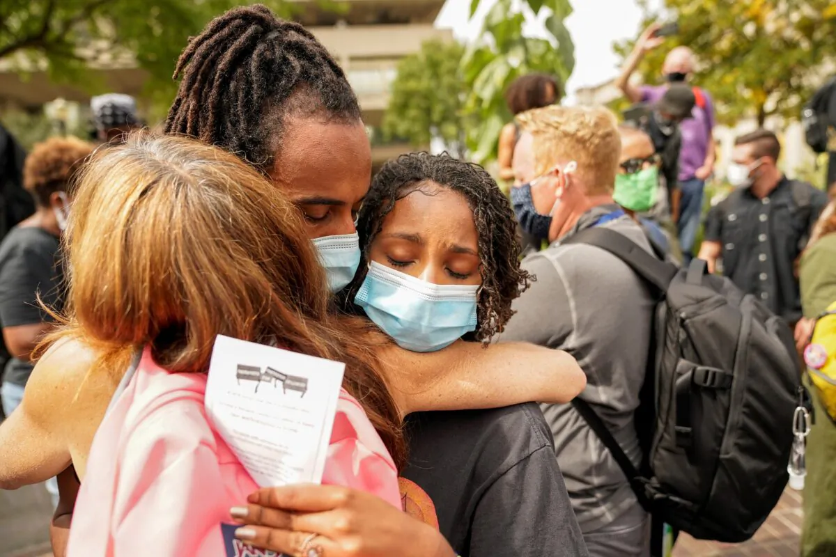 People react after a decision in the criminal case against police officers involved in the death of Breonna Taylor, who was shot dead by police in her apartment, in Louisville, Ky., Sept. 23, 2020. (Bryan Woolston/Reuters)