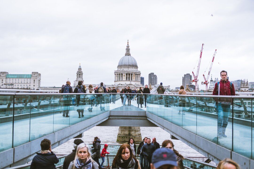 People are seen walking across Millennium Bridge in London in this file photo. (Luke Tanis/Unsplash.com)