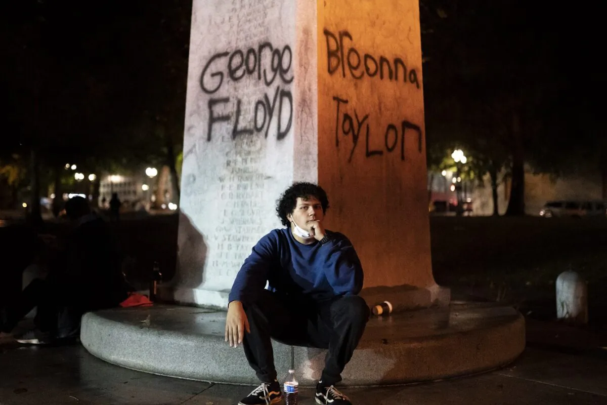 A protester catches his breath under the names of George Floyd and Breonna Taylor in Portland, Ore., on Sept. 23, 2020. (Nathan Howard/Getty Images)