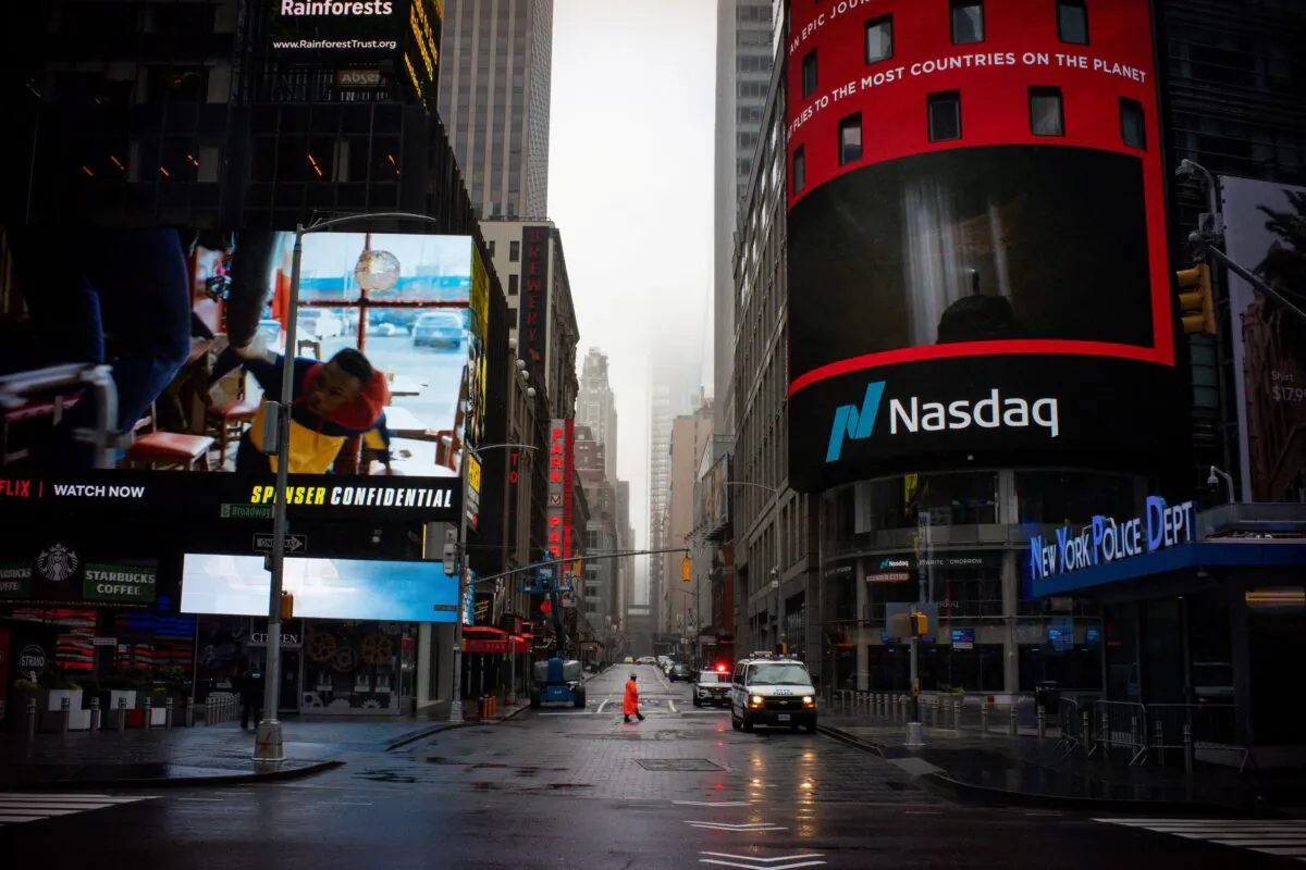 A man walks near Nasdaq MarketSite in an empty Times Square in New York City, on March 29, 2020. (Eduardo Munoz/Reuters)