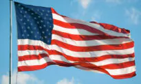 Patriotic Police Officer Caught on Door Cam Rolling Up Fallen US Flag, and the Video Goes Viral