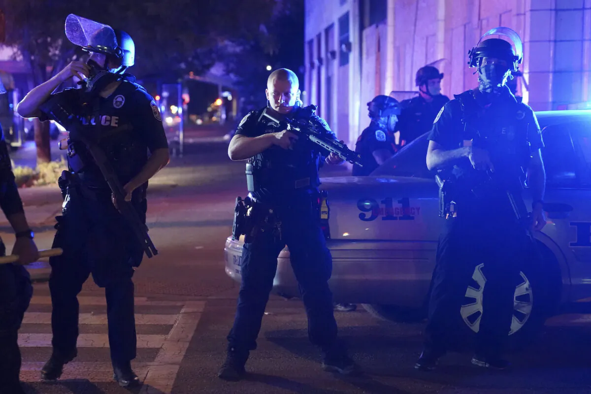 Police stand at an intersection after an officer was shot, in Louisville, Ky., on Sept. 23, 2020. (John Minchillo/AP Photo)