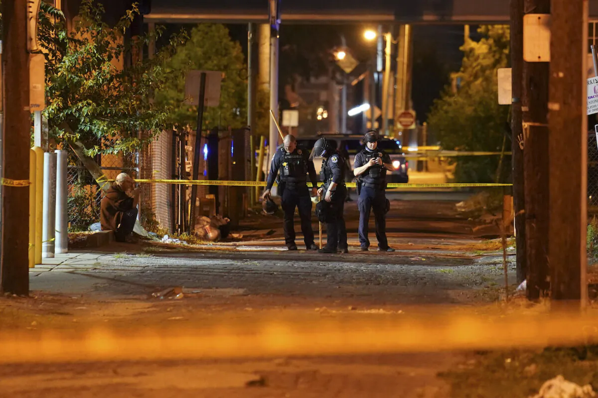 Police survey an area after a police officer was shot in Louisville, Ky., during rioting on Sept. 23, 2020. (John Minchillo/AP Photo)