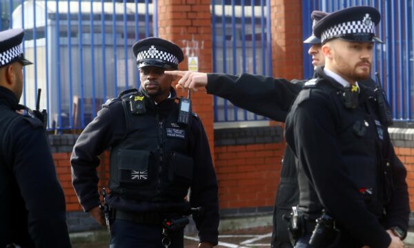 Policemen gather outside the custody centre