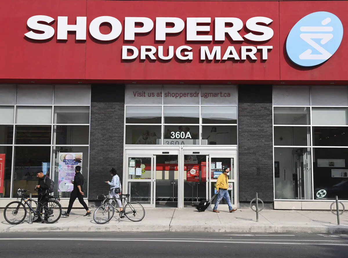 People leave a Shoppers Drug Mart where they are providing COVID-19 testing by appointment only during the COVID-19 pandemic in Toronto on September 25, 2020. (The Canadian Press/Nathan Denette)