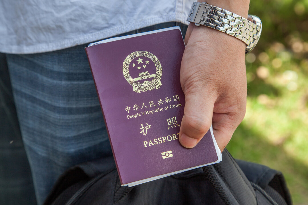 A Chinese national holds a Chinese passport on May 16, 2014. (Omar Havana/Getty Images)