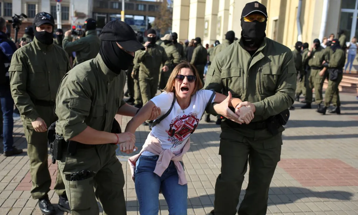 Belarusian law enforcement officers detain a woman during an opposition rally to reject the presidential election results and to protest against the inauguration of President Alexander Lukashenko in Minsk, on Sept. 26, 2020. (Tut.By via Reuters)