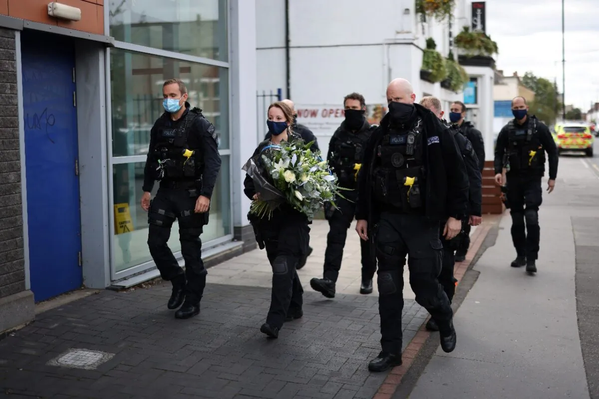 Police officers arrive to pay their respects at the custody center where a British police officer has been shot dead in Croydon, south London, Britain, on Sept. 26, 2020. (Simon Dawson/Reuters) 