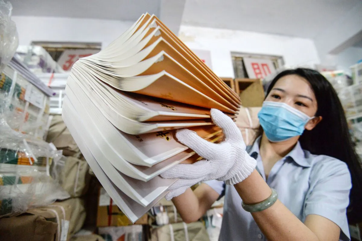 A staff member prepares textbooks at a bookstore ahead of the new school semester in Handan in China's northern Hebei Province on Aug. 24, 2020. (Photo by STR / AFP) / China OUT (Photo by STR/AFP via Getty Images)