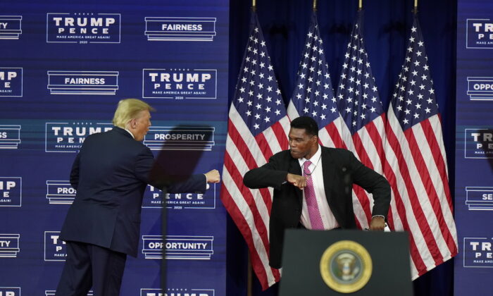President Donald Trump bumps elbows with Herschel Walker during a campaign rally in Atlanta on Sept. 25, 2020. (AP Photo/John Bazemore)