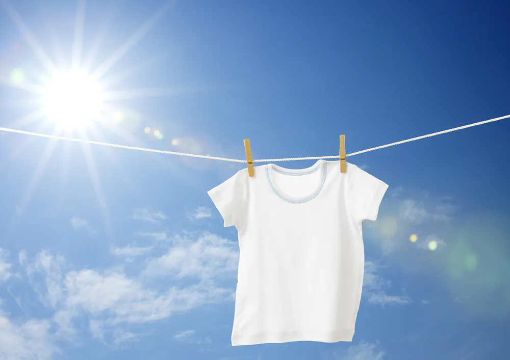 Rather than using bleach to remove perspiration stains from white T-shirts, you can try other options, such as white vinegar or hydrogen peroxide. (horiyan/Shutterstock)