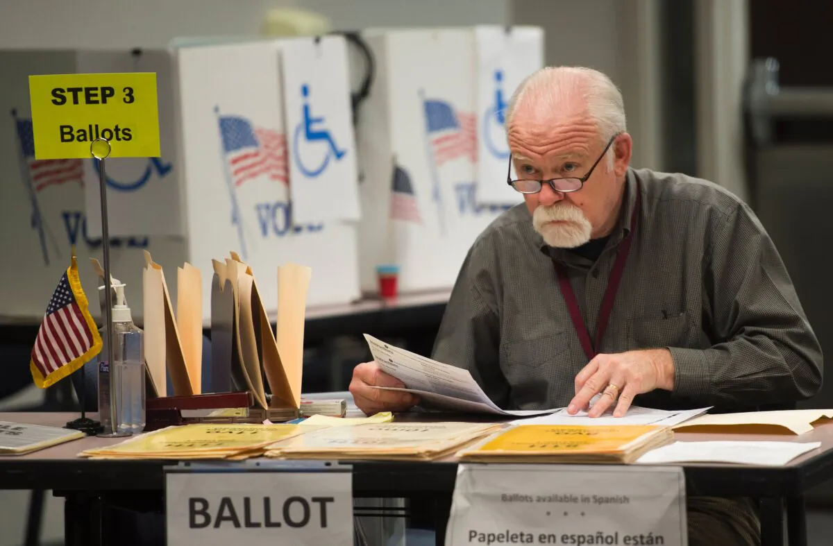 An election worker monitors at an in-person absentee voting station in Fairfax, Va., Oct. 25, 2016. (Andrew Caballero-Reynolds/AFP via Getty Images)