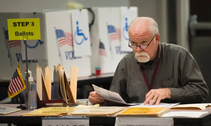 An election worker monitors at an in-person absentee voting station in Fairfax, Va., Oct. 25, 2016. (Andrew Caballero-Reynolds/AFP via Getty Images)