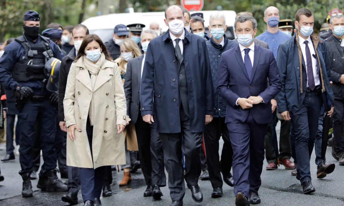 Paris mayor Anne Hidalgo (L), France Prime Minister Jean Castex, and Interior Minister Gerald Darmanin (R) arrive on the scene after a knife attack near the former offices of satirical newspaper Charlie Hebdo, on Sept. 25, 2020 in Paris. (Lewis Joly/AP Photo)

