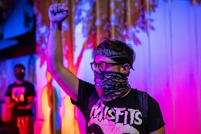A protester holds his fist in the air in Portland, Ore., on Sept. 6, 2020. (Nathan Howard/Getty Images)