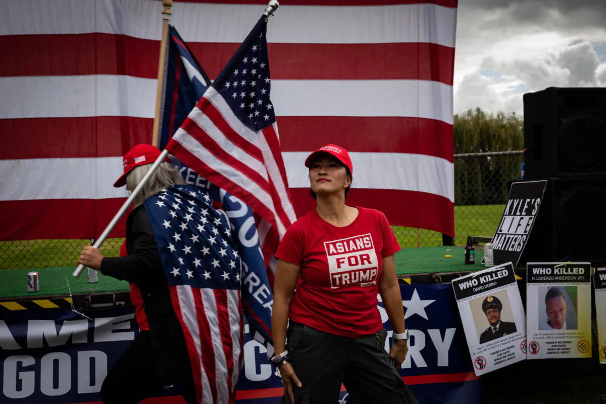 An attendee wearing a "Asians For Trump" shirt stands as several hundred members of the Proud Boys and similar groups gathered for a rally at Delta Park in Portland, Ore., on Sept. 26, 2020. (Maranie R. Staab/AFP via Getty Images)