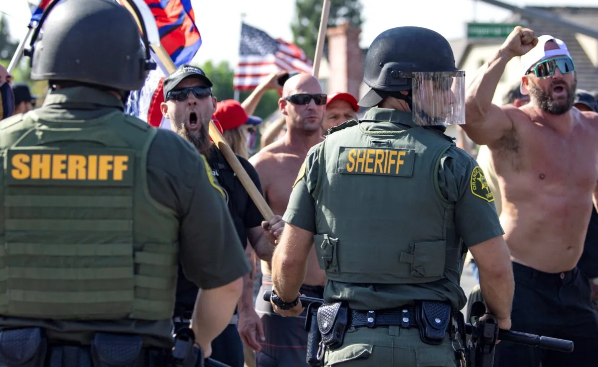 Orange County Sheriff deputies intervene to keep protesters and counter protesters from each other, in Yorba Linda, Calif., Sept. 26, 2020. (Mindy Schauer/The Orange County Register via AP)