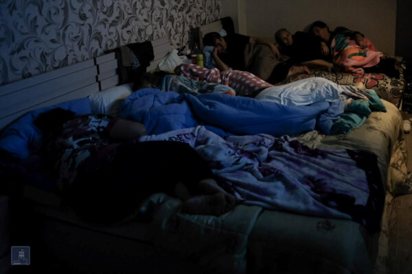 People are seen in a bomb shelter