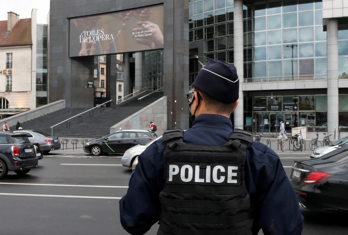 A French police officer stands near the Opera Bastille where a suspect in a stabbing attack near the former offices of the magazine Charlie Hebdo was arrested in Paris, on Sept. 25, 2020. (Gonzalo Fuentes/Reuters)