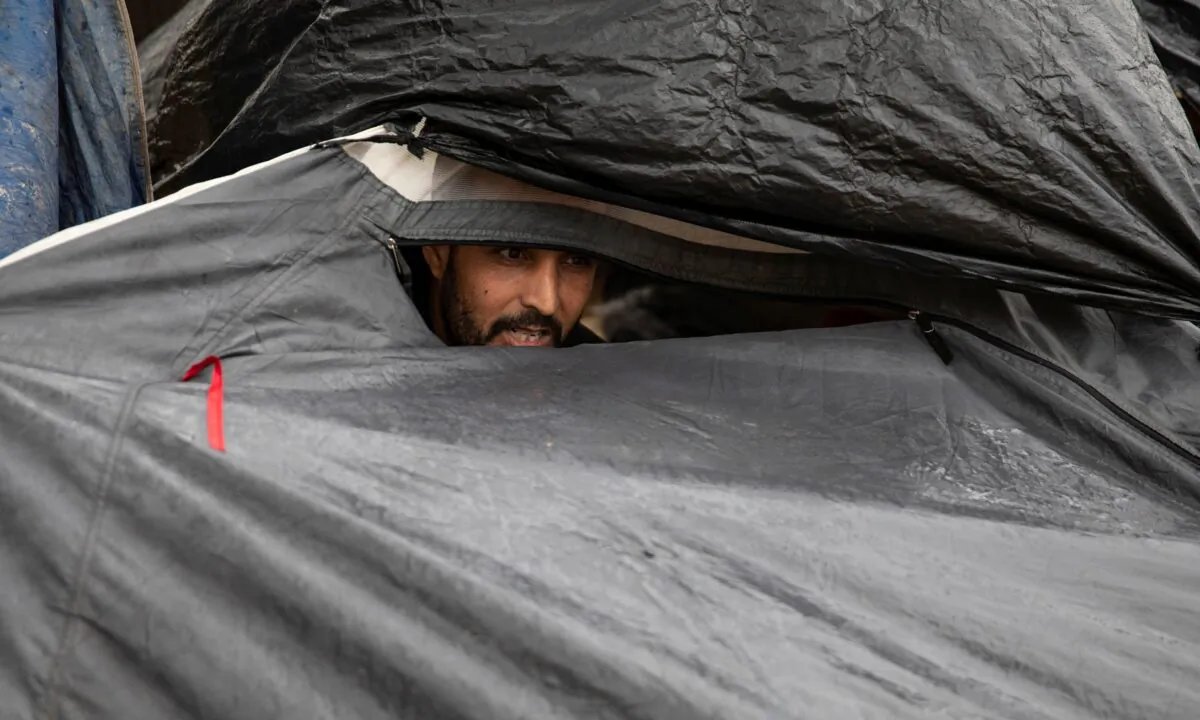 A migrant sits in his tent at One Stop Center for Migrants, near the border with Hungary in Subotica, Serbia, on Sept. 25, 2020. (Marko Djurica/Reuters)