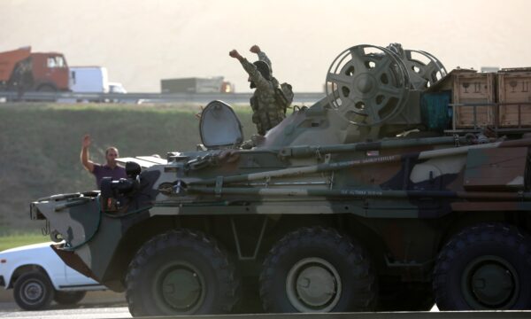 An Azerbaijani service member drives an armoured carrier