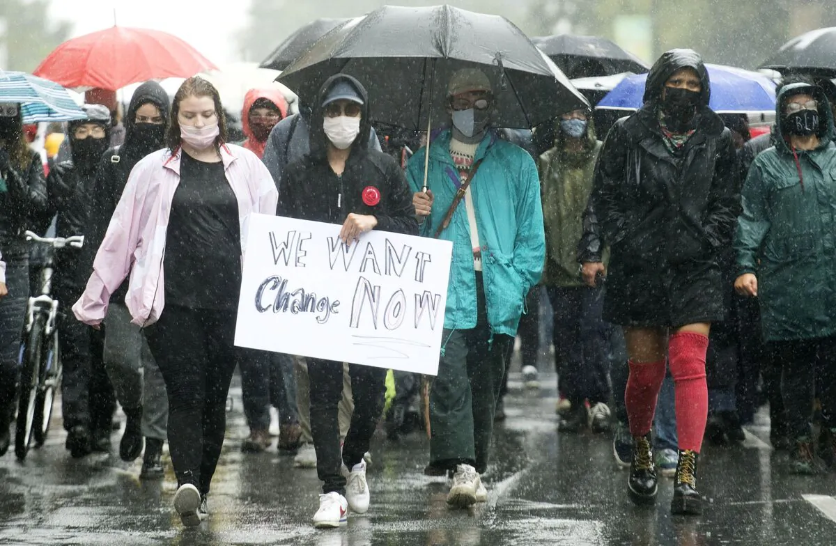 People attend a demonstration calling for defunding the police with a goal to end systemic racism within all sectors of the Canadian government, in Montreal on Aug. 29, 2020. (The Canadian Press/Graham Hughes)
