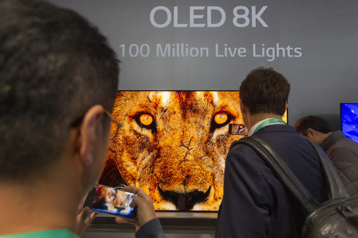 People look at OLED 8K television screens at an exhibit of the 2020 Consumer Electronics Show in Las Vegas, Nev., on Jan. 7, 2020. (David McNew/AFP via Getty Images)