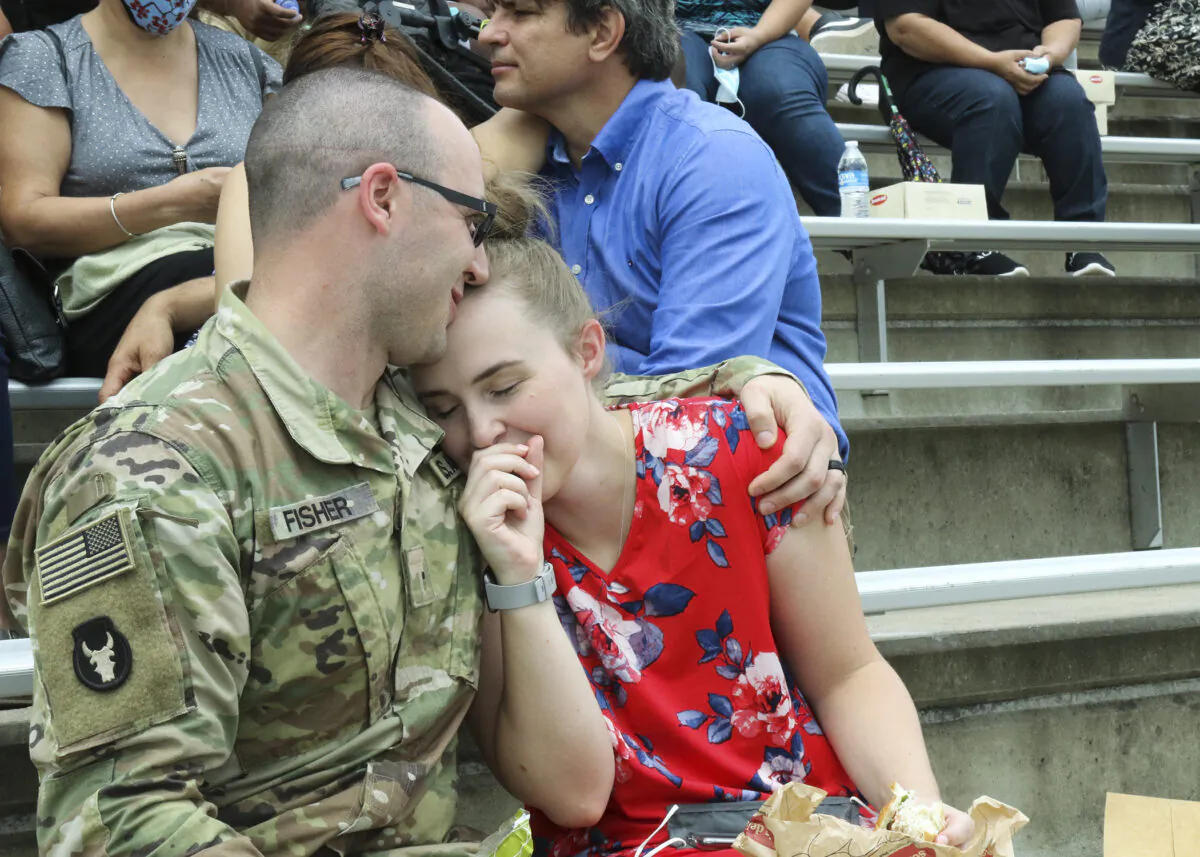 AUSTIN, Texas -- The 36th Infantry Division Headquarters officially cases their colors in preparation for their upcoming deployment at a ceremony Sunday, Sept. 27, 2020, at the Kelly Reeves Athletic Complex of Round Rock in Austin, Texas. The Arrowhead Soldiers and their families gathered for the ceremony and said their final farewells as the headquarters Soldiers loaded the buses to leave. When a unit cases its colors, the commander and senior enlisted non-commissioned officer rolled up the unit’s flag and sheath it for transport. This symbolically represents the official duty location change or forward deployment movement of the command of a unit and its Soldiers. (U.S. Army photo by Staff Sgt. Michael Giles, 36th Infantry Division Public Affairs)