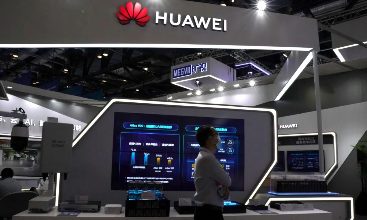 A man wearing a face mask following the COVID-19 outbreak walks past a booth of Huawei at the 2020 China International Fair for Trade in Services (CIFTIS) in Beijing, China, on Sept. 4, 2020. (Tingshu Wang/Reuters)