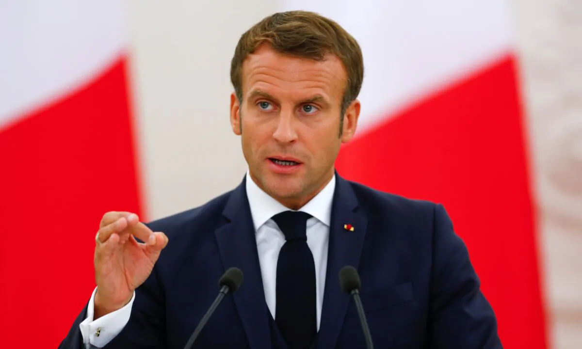 French President Emmanuel Macron gestures as he speaks during a news conference in Vilnius, Lithuania, on Sept. 28, 2020. (Ints Kalnins/Reuters)