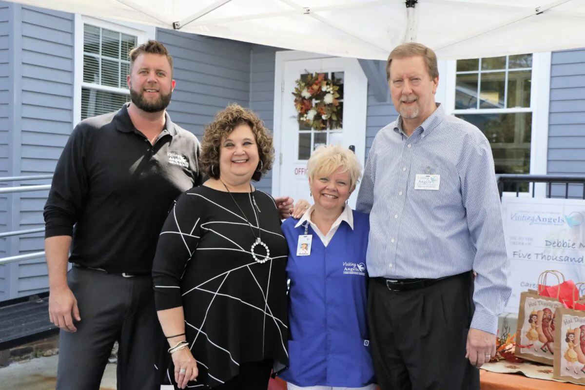 Debbie Moorefield (2nd R) provides in-home and end-of-life care for the elderly. (Courtesy of Visiting Angels)