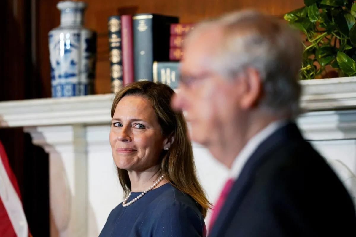 Senate Majority Leader Mitch McConnell (R-Ky.) meets with Supreme Court nominee Judge Amy Coney Barrett on Capitol Hill in Washington on Sept. 29, 2020. (Susan Walsh/Pool via Reuters)