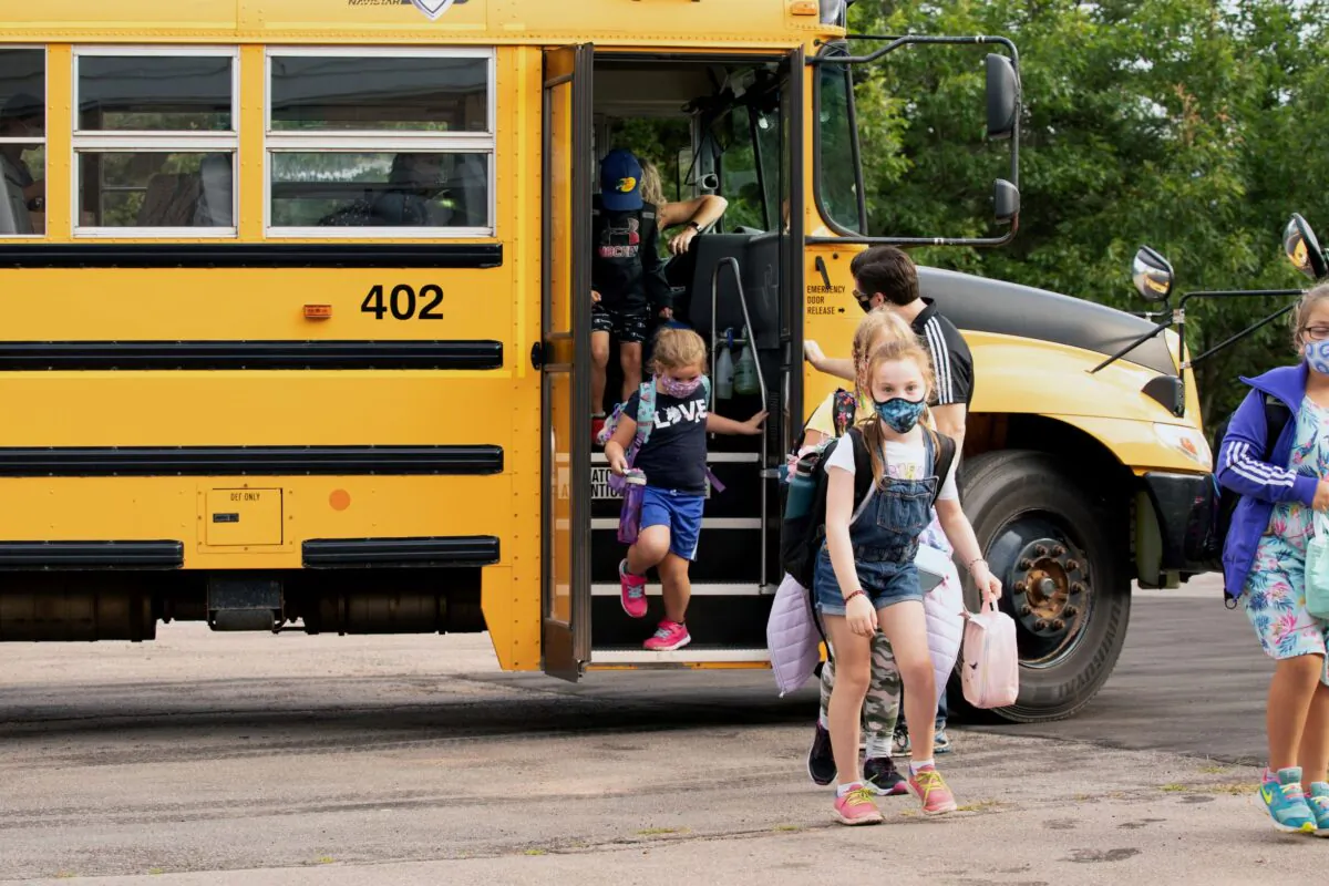 Students get off the school bus in Vernon Bridge, Prince Edward Island, on Sept. 8, 2020. (Reuters/John Morris)