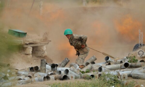 An ethnic Armenian soldier fires an artillery piece