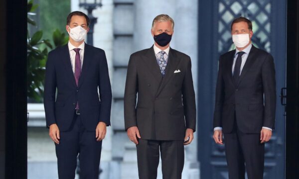 Alexander De Croo and Paul Magnette pose with Belgium's King Philippe