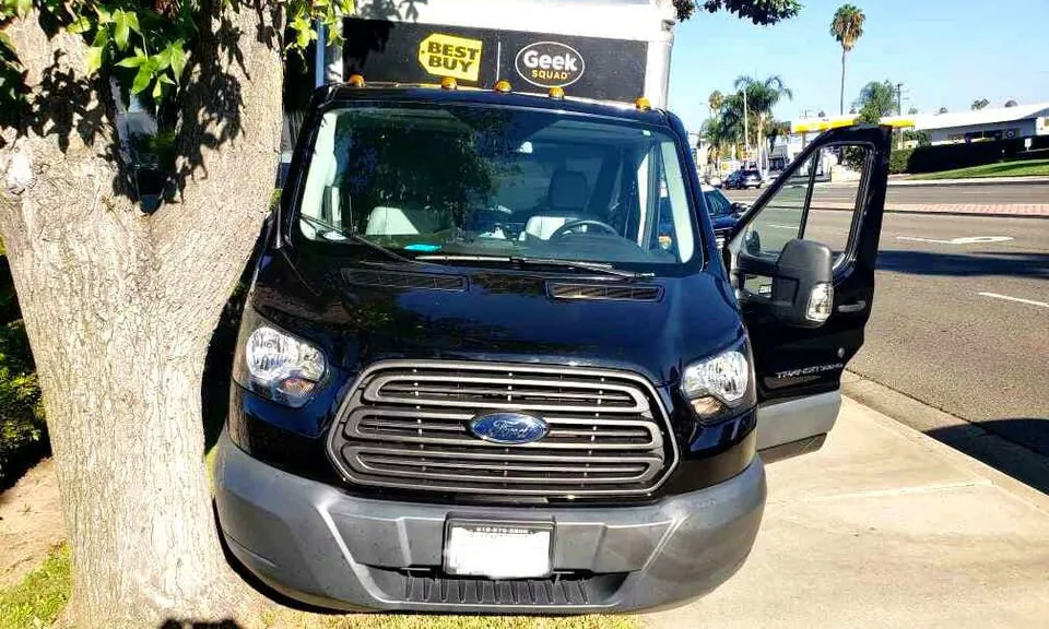 A stolen Geek Squad truck used by Best Buy stores to deliver goods to customers is seen crashed into a tree following a high-speed chase in Santa Ana, Calif., on Sept. 24, 2020. (Courtesy of CHP–Santa Ana)