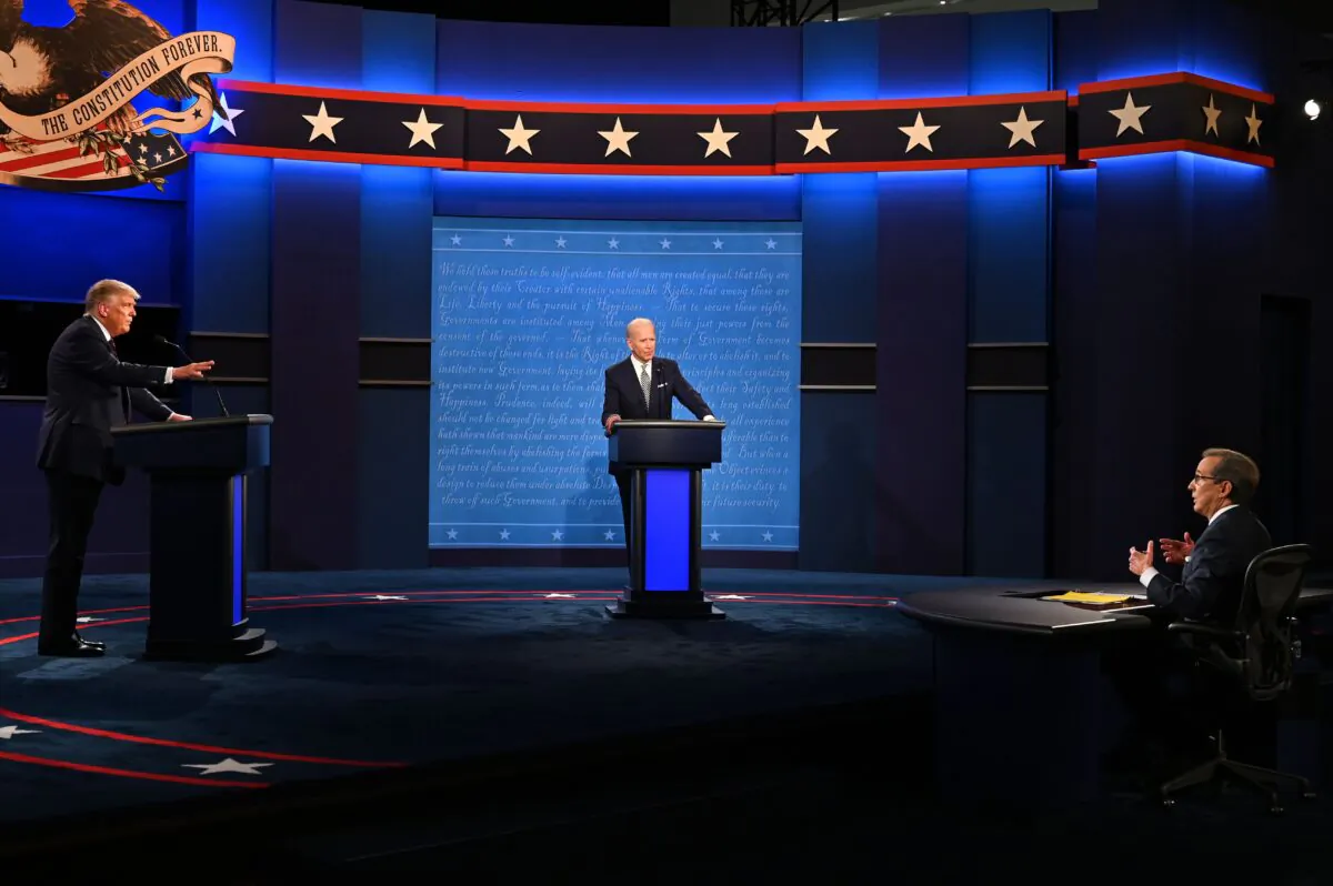 President Donald Trump (L) and former US Vice President Joe Biden (C) and moderator and Fox News anchor Chris Wallace (R) speak during the first presidential debate at the Case Western Reserve University and Cleveland Clinic in Cleveland, Ohio on Sept. 29, 2020. (JIM WATSON/AFP via Getty Images)