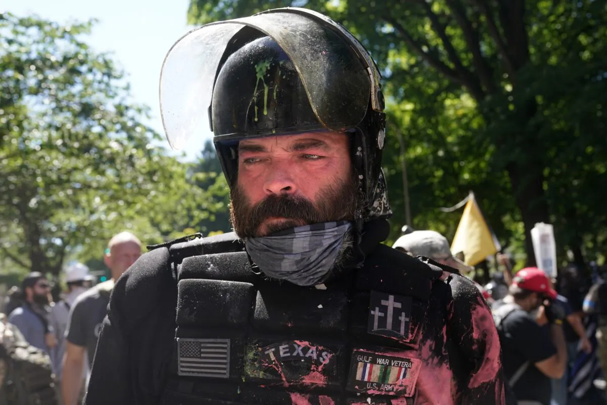 Alan Swinney walks through a crowd in Portland, Ore., Aug. 22, 2020. (Nathan Howard/Getty Images)