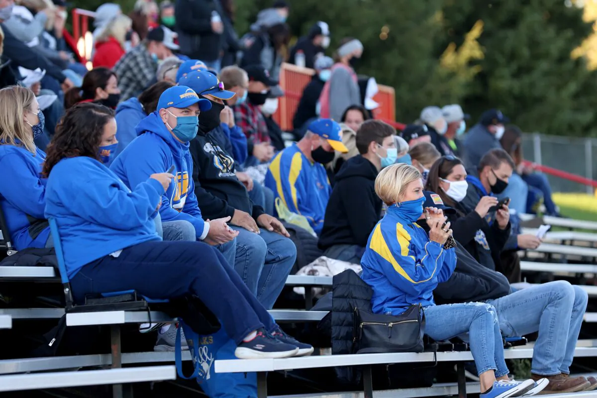 Fans sit in the stands wearing masks during a high school football game in Clinton, Mich., Sept. 18, 2020. (Justin Casterline/Getty Images)
