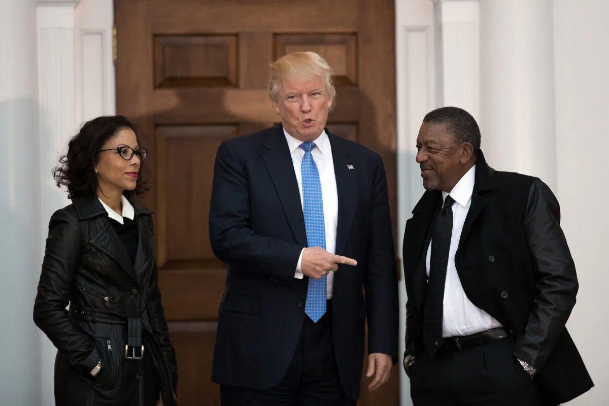 Donald Trump (C) greets Robert Johnson (R), the founder of Black Entertainment Television, and his wife Lauren Wooden (L) at Trump International Golf Club, in Bedminster Township, New Jersey, on Nov. 20, 2016. (Drew Angerer/Getty Images)