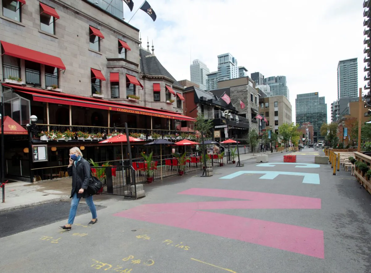 A woman walks past the bars on Crescent street on September 30, 2020 in Montreal. (The Canadian Press/Ryan Remiorz)