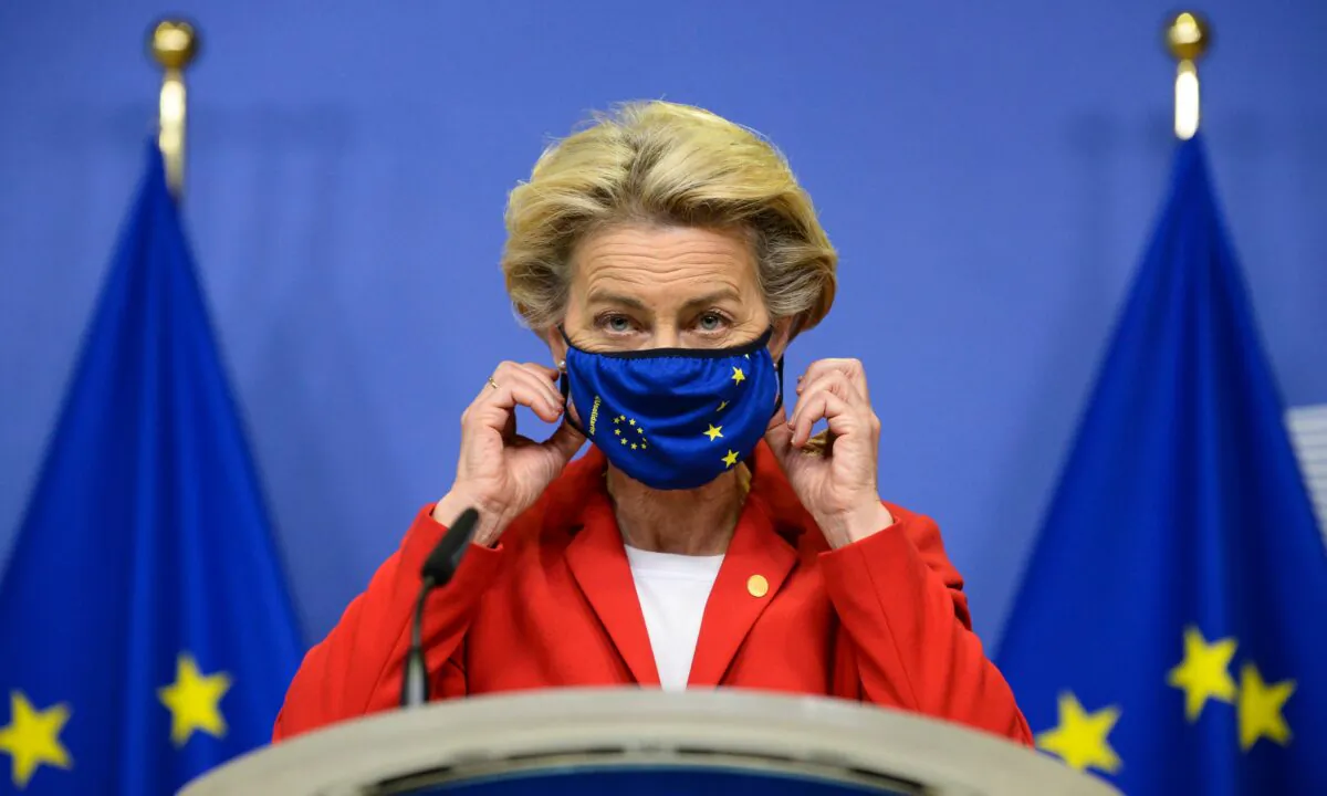 European Commission President Ursula von der Leyen takes off her face mask prior to making a statement regarding the Withdrawal Agreement at EU headquarters in Brussels, on Oct. 1, 2020. (Johanna Geron/Pool via AP)