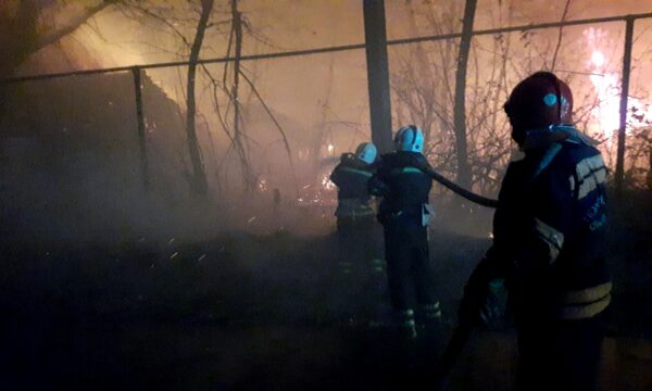 Firefighters work at a settlement