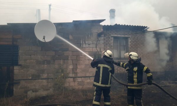 Firefighters work at a settlement