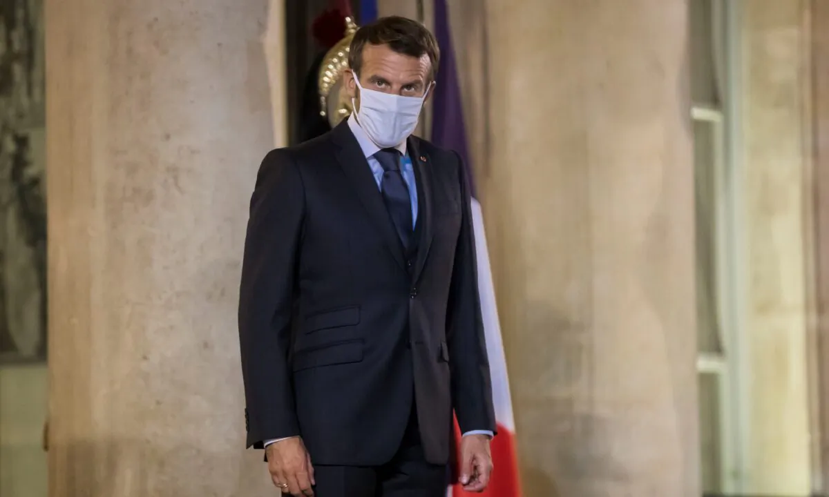 French President Emmanuel Macron stands during a meeting with Kenyan President Uhuru Kenyatta at the Elysee Palace in Paris, on Sept. 30, 2020. (Christophe Petit Tesson/Pool via Reuters)
